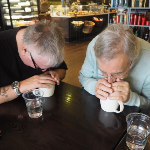 Photo shows two male members, taking part in the sensory coffee tasting at Starbucks. Both are using their senses to smell the coffee in the mug at Starbucks Monks Cross, York.