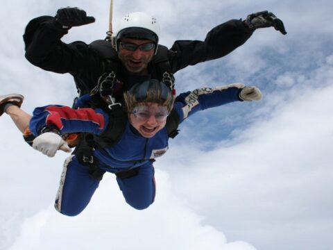 A woman taking part in a sky dive for MySight York, the instructor is with her as they are sky diving