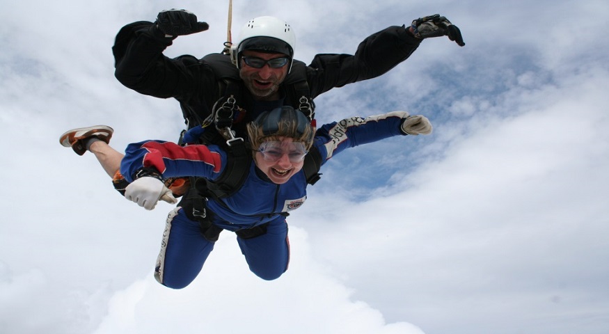 A woman taking part in a sky dive for MySight York, the instructor is with her as they are sky diving