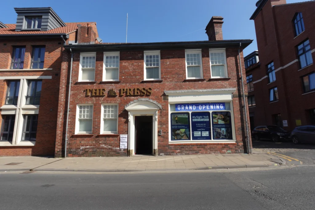 Front view of the MySight York building on Walmgate. A large display window on the right features a Grand Opening banner and MySight York signage.