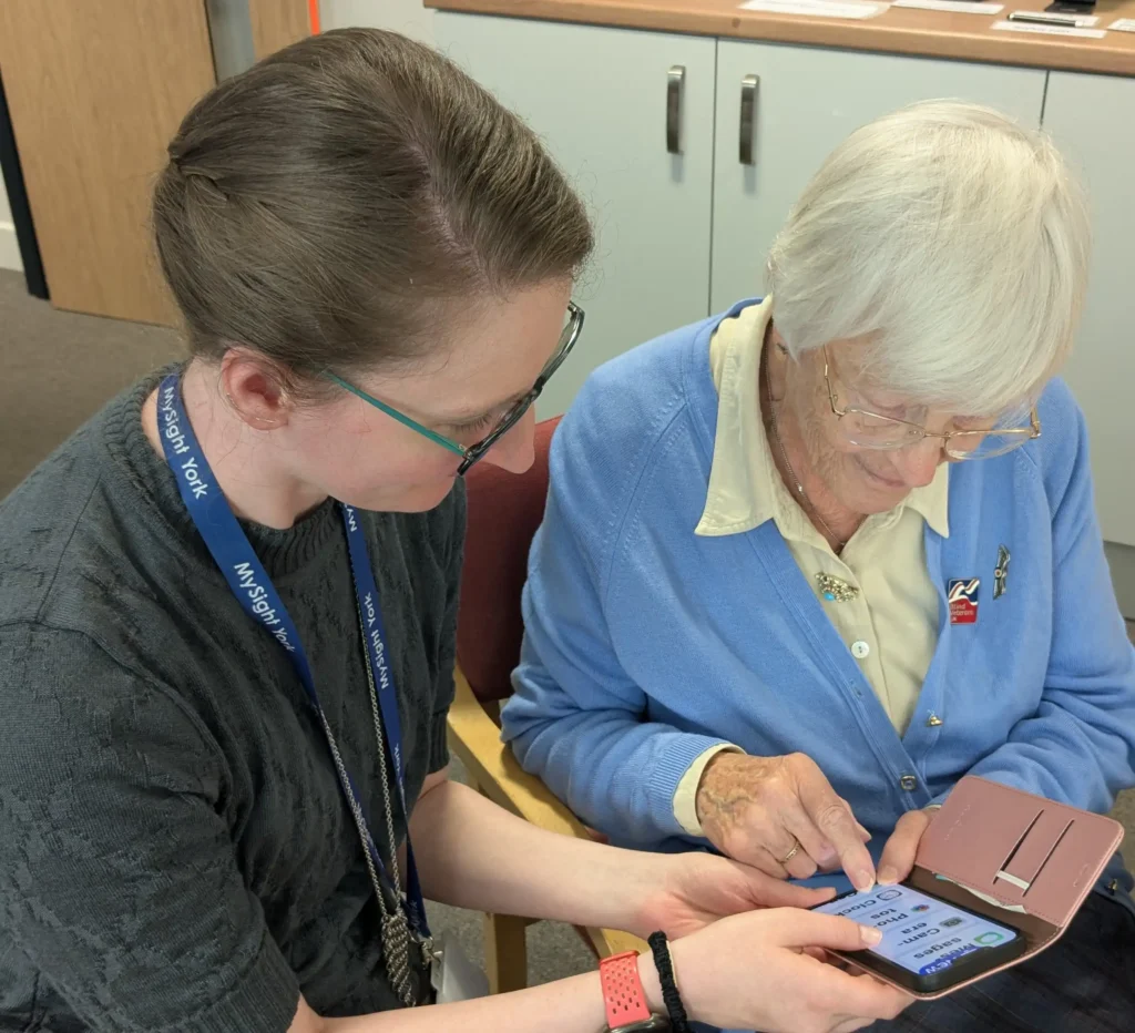 MySight York staff, Bex, supporting a member with her mobile phone.